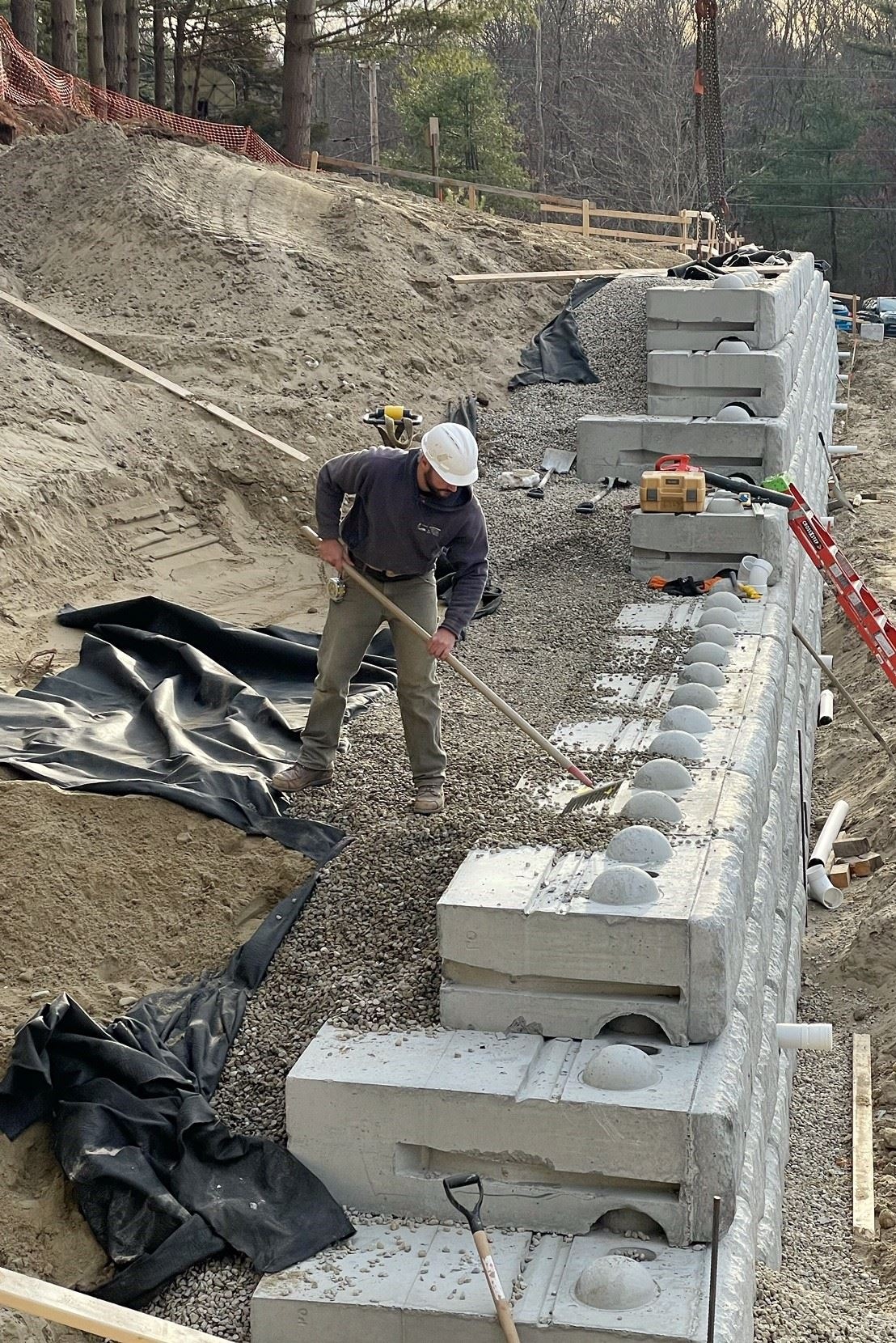 installing Stone and Fabric Behind Block Retaining Wall